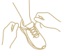 A line drawing of a person in a wheelchair being assisted by a caregiver, with the caregiver holding a helping hand, representing support and assistance with daily living activities.