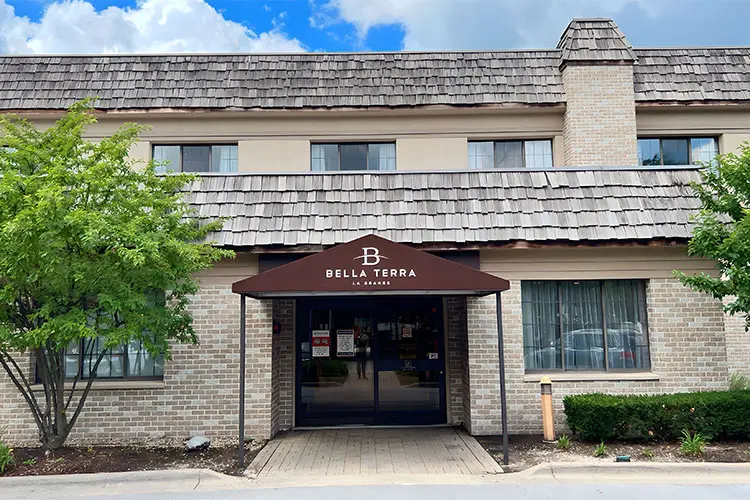 The image shows the entrance of a building with a sign that reads 